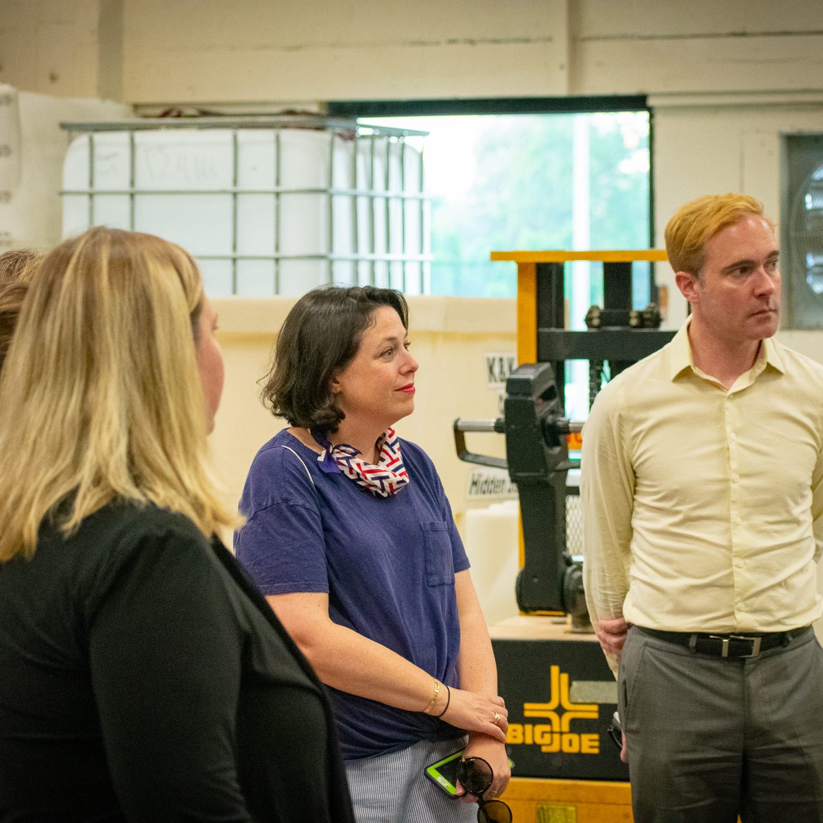 Group listens intently to Master Distiller, Coty Edwards (off camera)